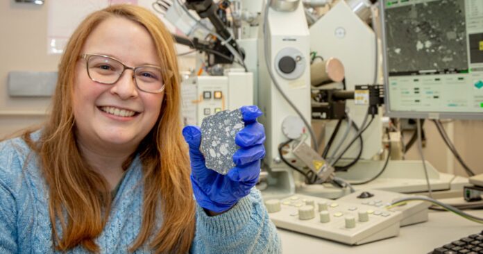 Western postdoctoral fellow Tara Hayden with a lunar meteorite, which was not a part of the study, in the Earth and Planetary Materials Analysis Laboratory. (Christopher Kindratsky/Western Communications photo)